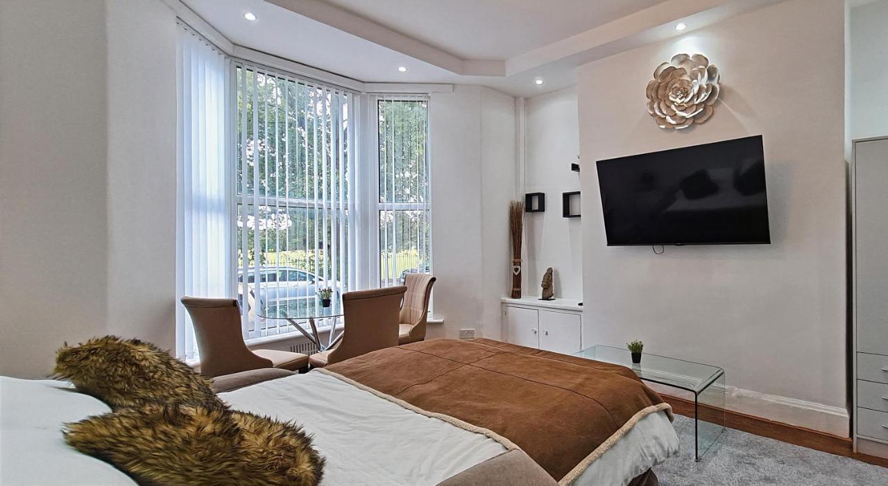 a bedroom with a bed and a tv on a wall at Sidemersey Livings - Botanic Residence in Liverpool